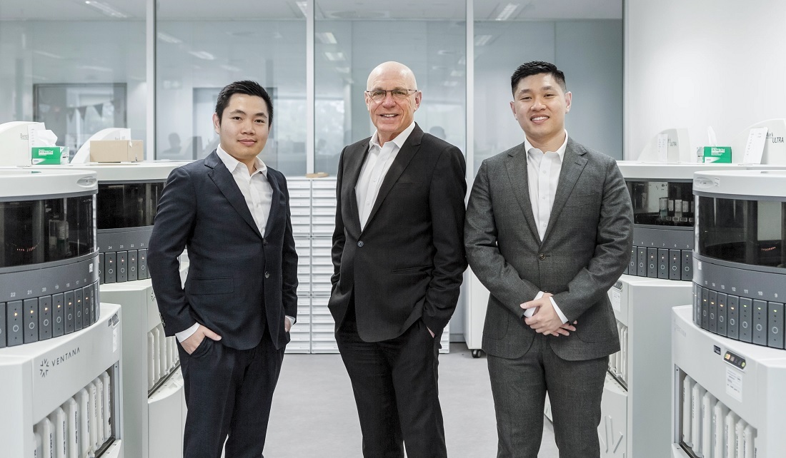 three men smiling at camera