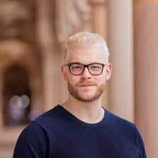 Profile photo of Dr Thomas Shaw standing in the great court