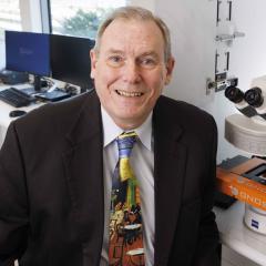 Professor Brian Lovell sits in the SNP laboratory