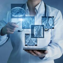 Doctor holds notepad with holograph medical imaging above