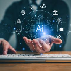 Man types with one hand, and holds virtual AI sign in the other